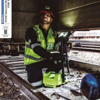 Copertă catalog Peli RALS, în care un mecanic de locomotivă utilizează o lampă de lucru portabilă cu LED Peli într-un tunel.